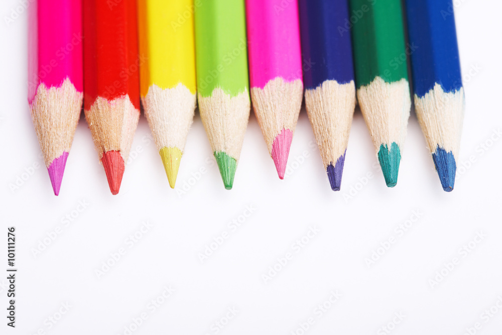 Colored pencils on white. Top view. Colored pencils on white. Top view.