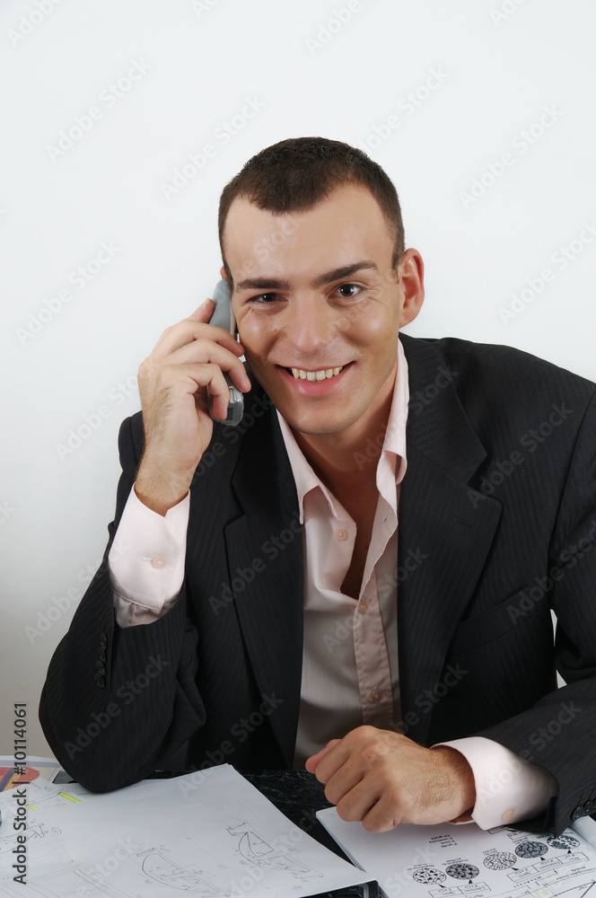 Young smiling business man in office isolated on white Young smiling business man in office isolated on white