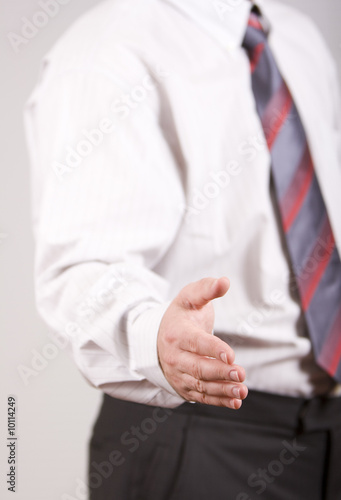Businessman is ready for a handshake (focus on a hand)
