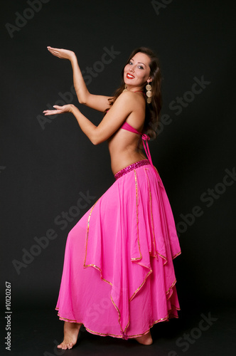 attractive woman dancing belly dance over black