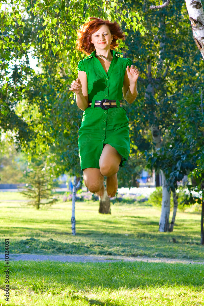 Young beautiful woman jumps with happiness Young beautiful woman jumps with happiness