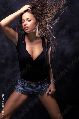 beautiful young woman dancing, studio dark © Coka