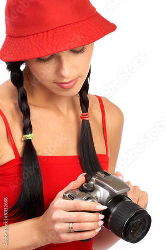 Young beautiful smiling woman holding a photo camera.. © grinny