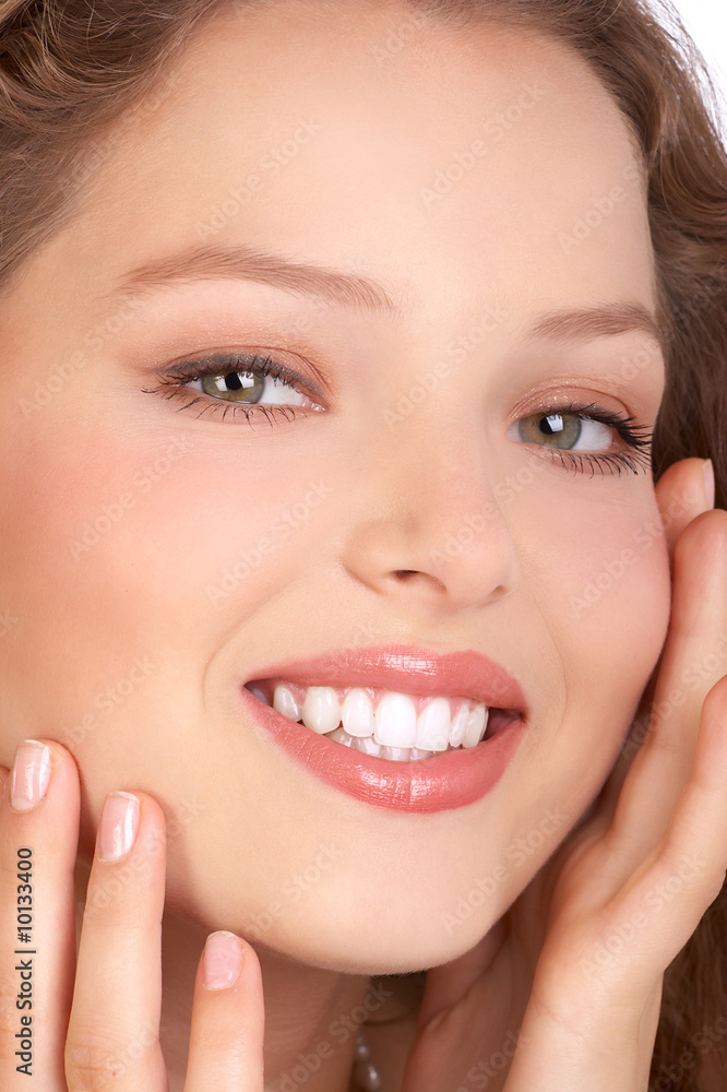Beautiful young smiling woman touching her face Beautiful young smiling woman touching her face