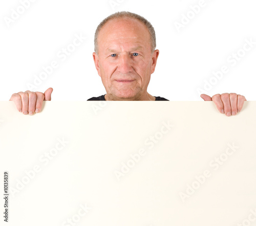 Senior man holding blank poster
