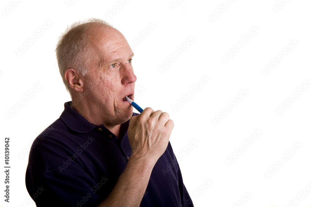 An older bald man brushing his teeth An older bald man brushing his teeth