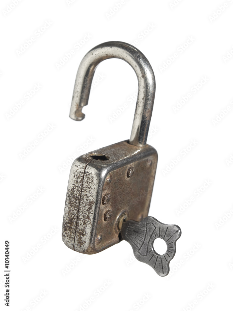 An open lock with a key isolated on white background. An open lock with a key isolated on white background.