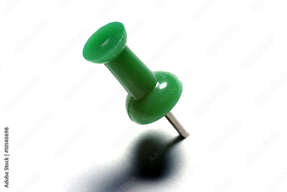 Macro of green drawing pin isolated on white background. Macro of green drawing pin isolated on white background.