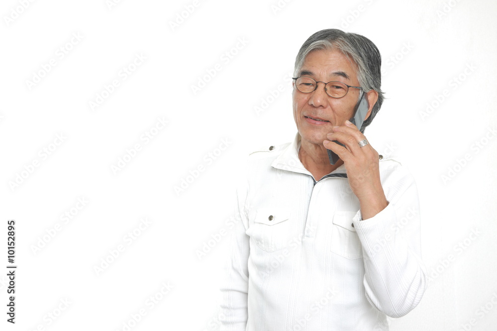 senior man talks with a mobile phone senior man talks with a mobile phone