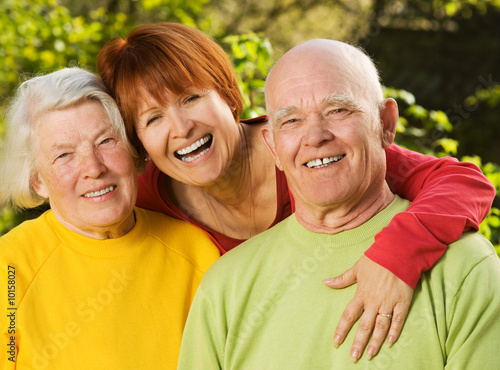 Senior couple with their daughter outdoors