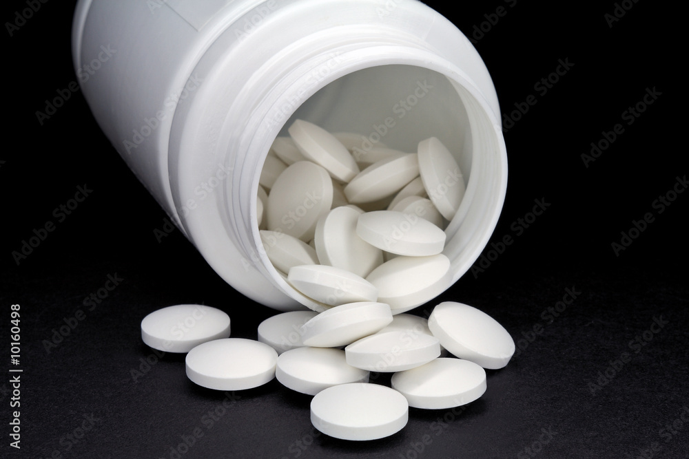Pills, poured out from a small bottle