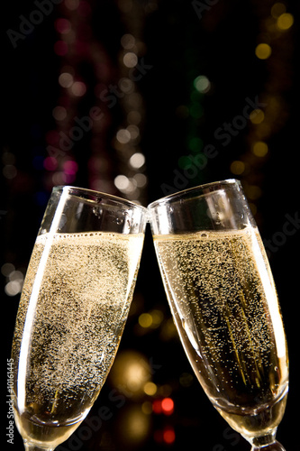 Champagne glasses making toast over holiday background