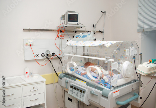 newborn baby sleeping in an incubator in hospital.