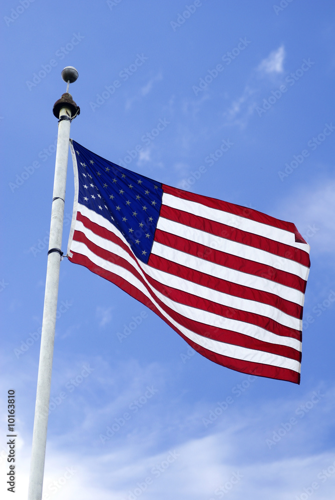 an american flag on a tall pole