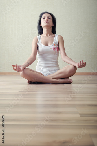 Woman in lotus position meditating in a yoga training