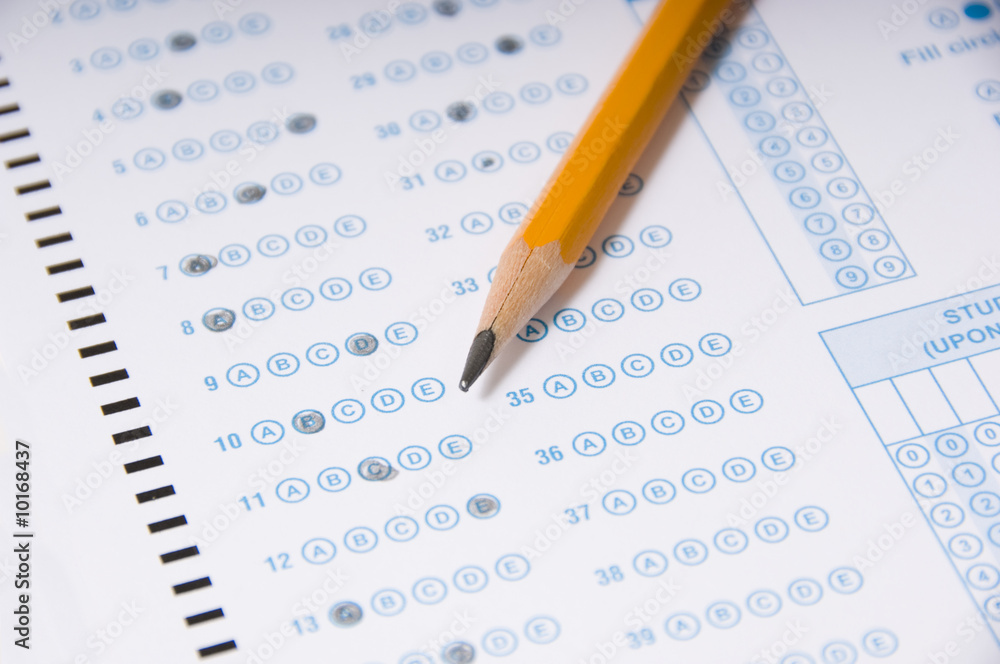 A yellow pencil on a computer read examination or test A yellow pencil on a computer read examination or test