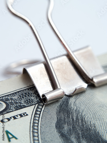 US dollars notes binded by paper-clip isolated white