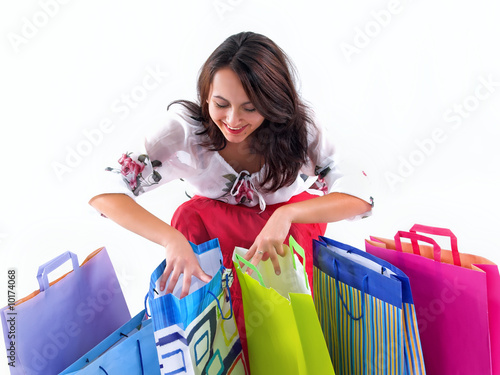 Shopping girl look over shopping bags,isolated on white photo