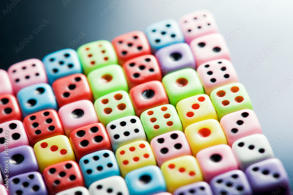 Plastic colorful dices over glass surface Plastic colorful dices over glass surface