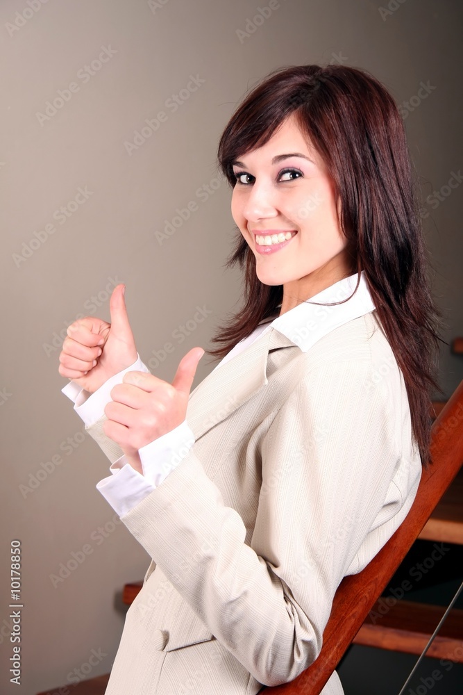 Gorgeous businesswoman showing the thumbs up sign Gorgeous businesswoman showing the thumbs up sign