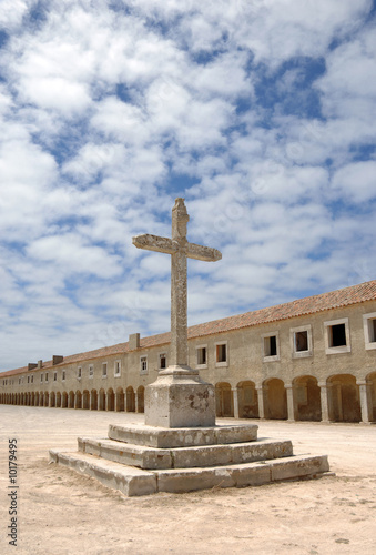 Cross with old monastery in background, Portugal