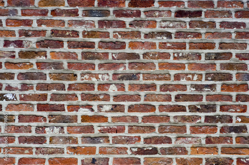 Roough red bricks and motar with the mortar outlinging the brick