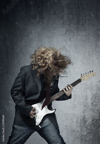 Electric guitar player on a trash background photo