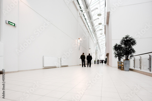 White hall of office centre, people move