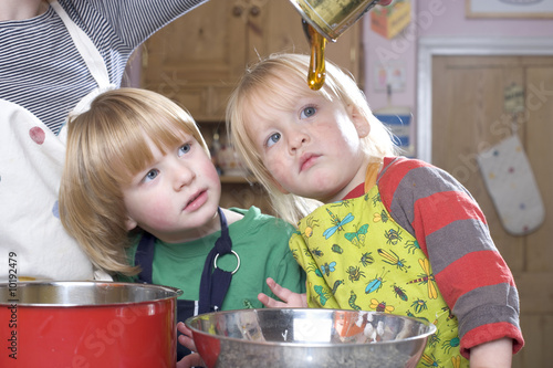 young family cooking in the kitchin photo