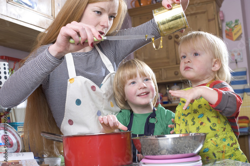 young family cooking in the kitchin photo