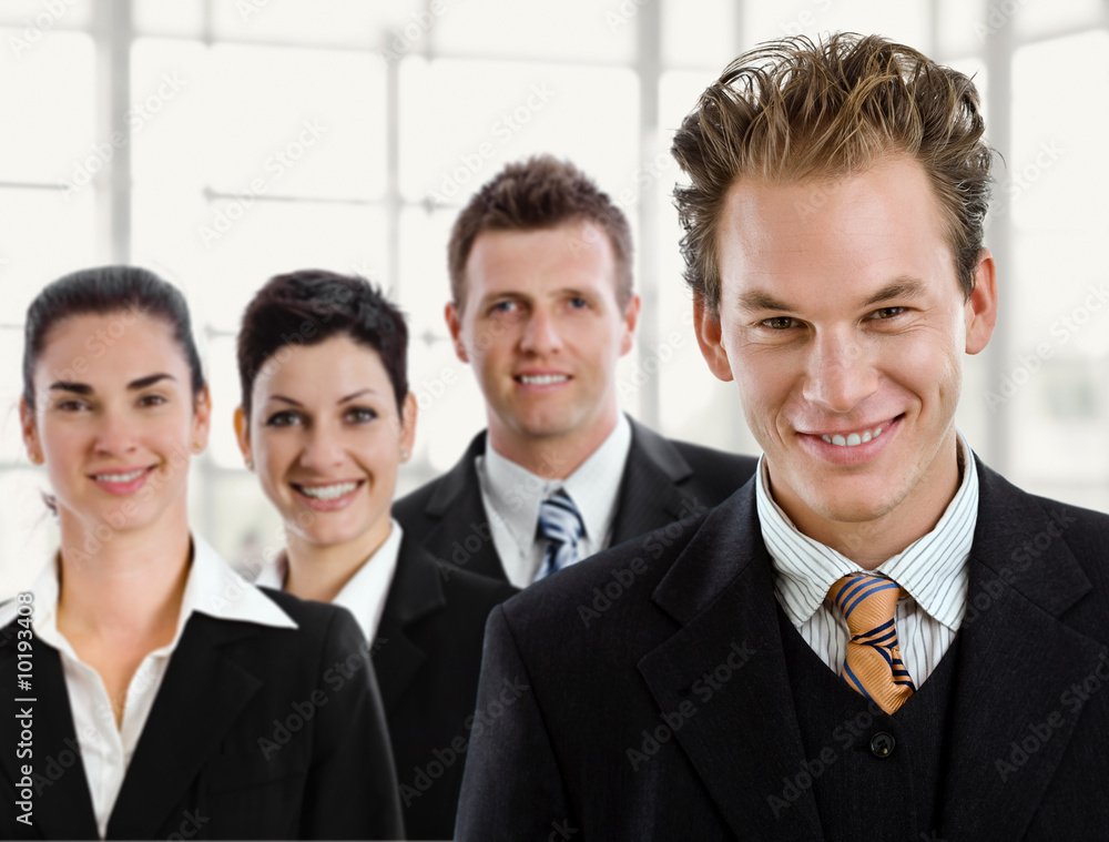 Team of happy business people, smiling businessman in front. Team of happy business people, smiling businessman in front.