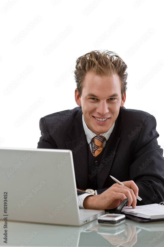 Businessman working on laptop computer, smiling, Businessman working on laptop computer, smiling,