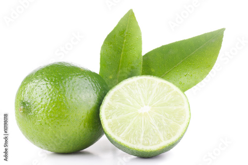 green lemon and leaves isolated on white