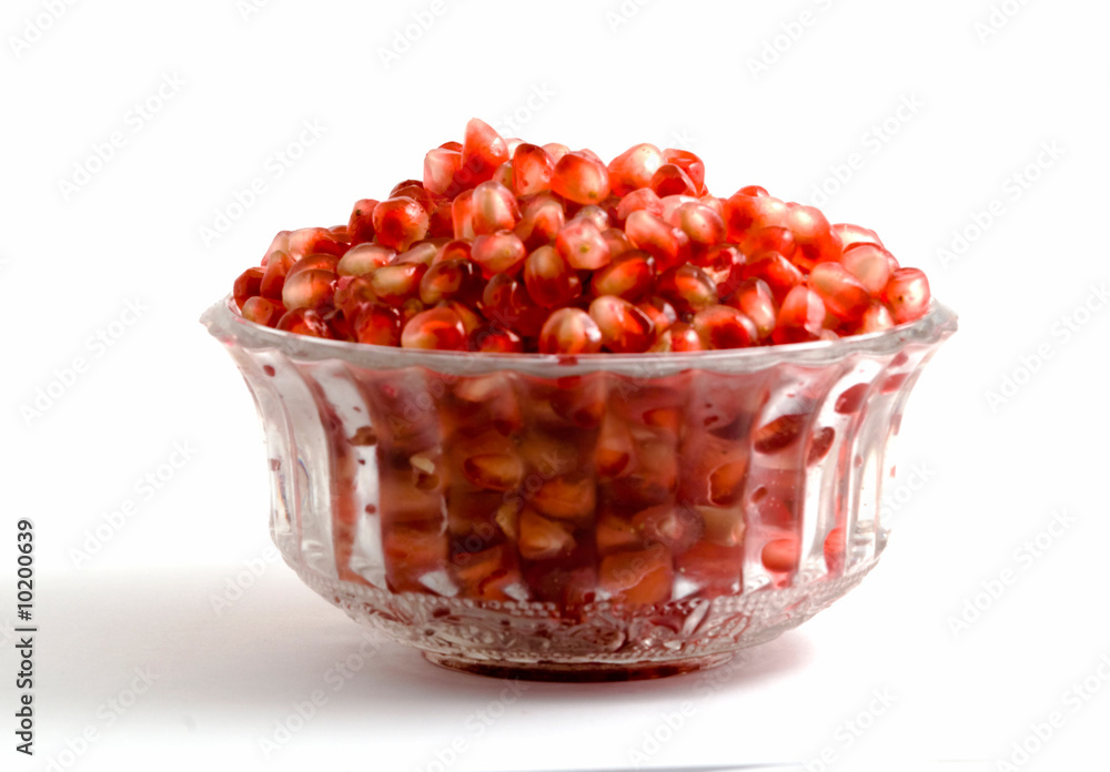 Goblet full of pomegranate arils isolated on white background Goblet full of pomegranate arils isolated on white background