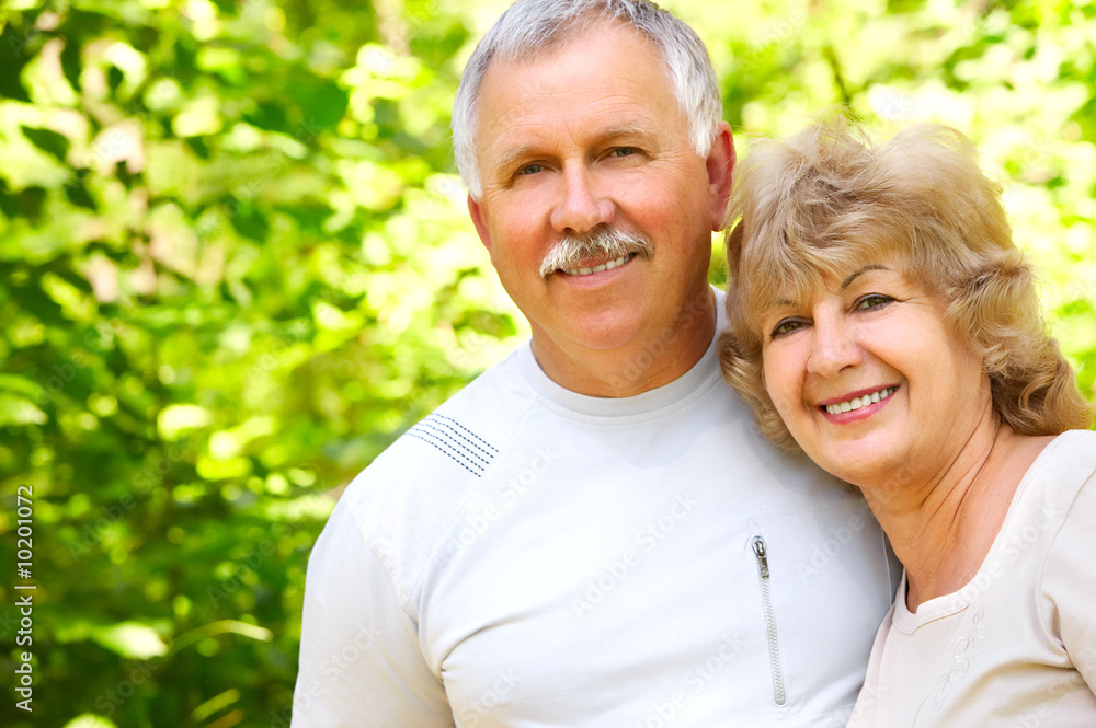 Smiling happy elderly couple in love in the forest. Smiling happy elderly couple in love in the forest.