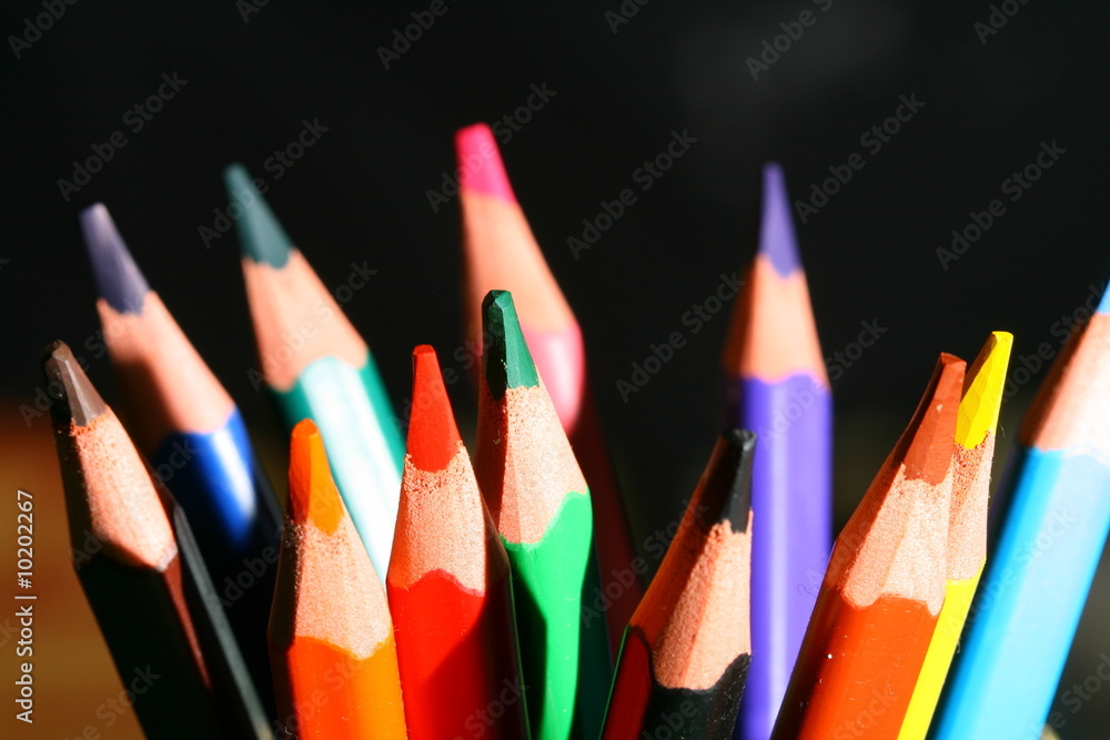 Fototapeta colour pencils on black macro close up