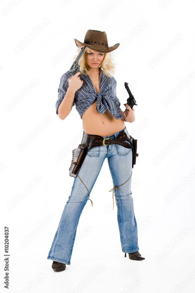 Young blonde woman in cowboy clothes with guns Young blonde woman in cowboy clothes with guns