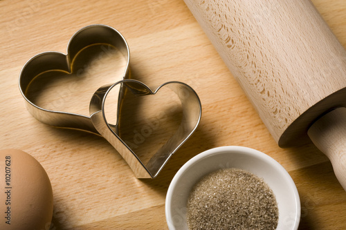 heart shaped cookie cutters, rolling pin, egg, vanilline sugar photo