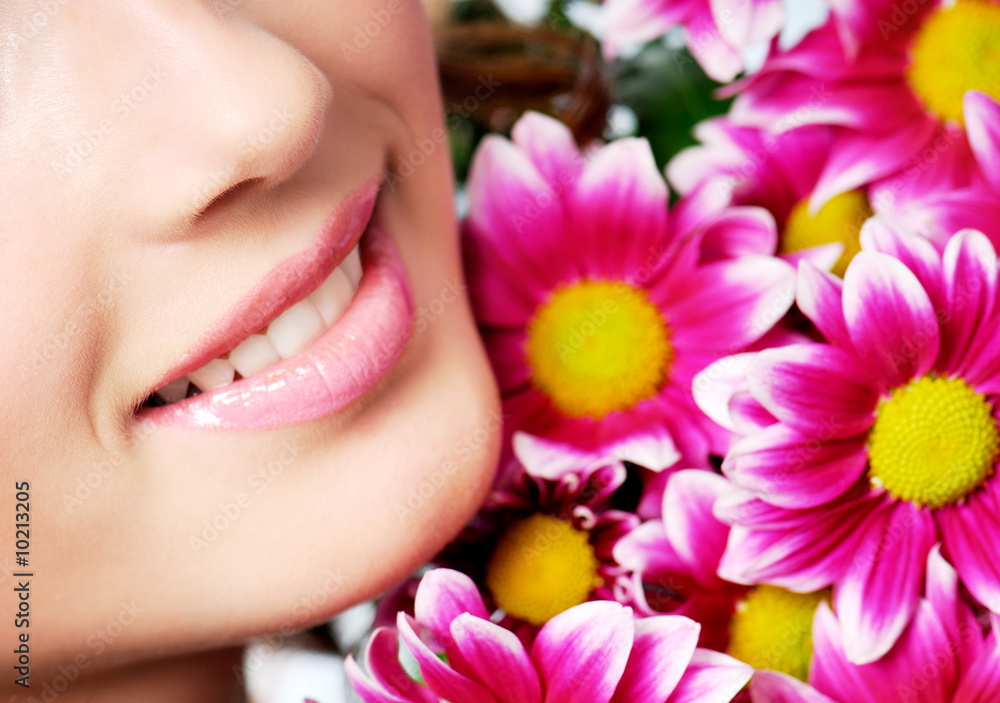 girl healthy smile  with pink chrysanthemum on a background