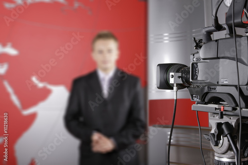 TV studio with video camera and unrecognizable presenter photo