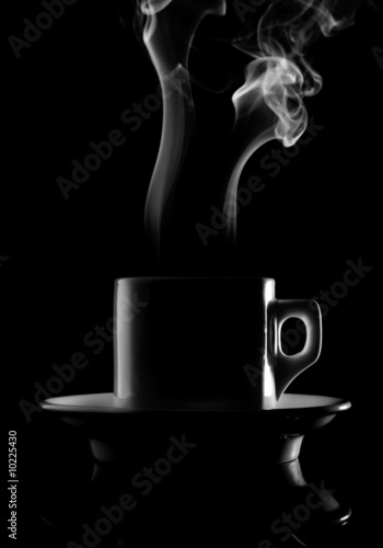 Cup of hot drink with steam isolated over black background