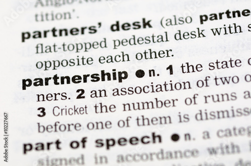 A close up of the word partnership from a dictionary