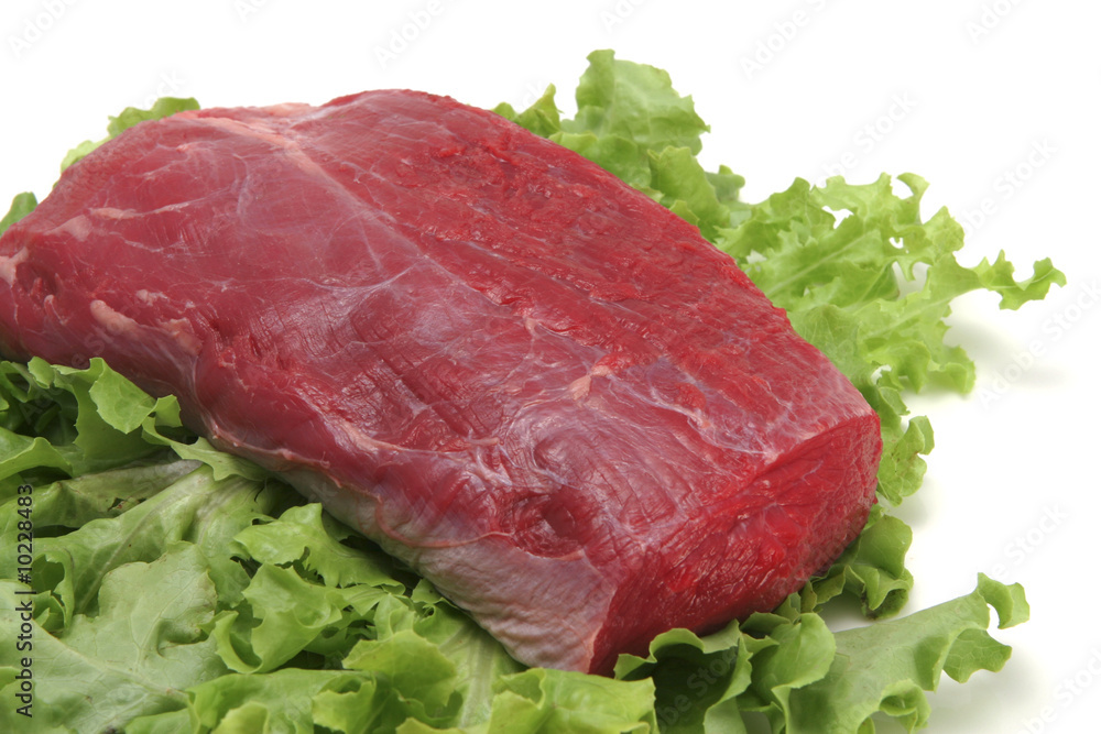 beef meat on white plate close-up