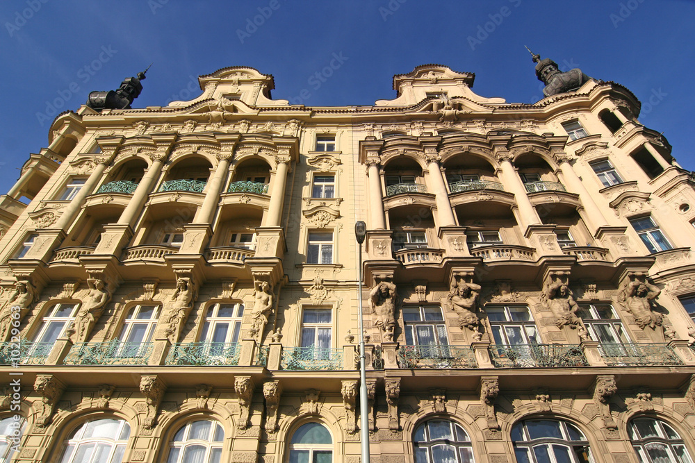 Classic mansions with statues and balconies in Prague Classic mansions with statues and balconies in Prague