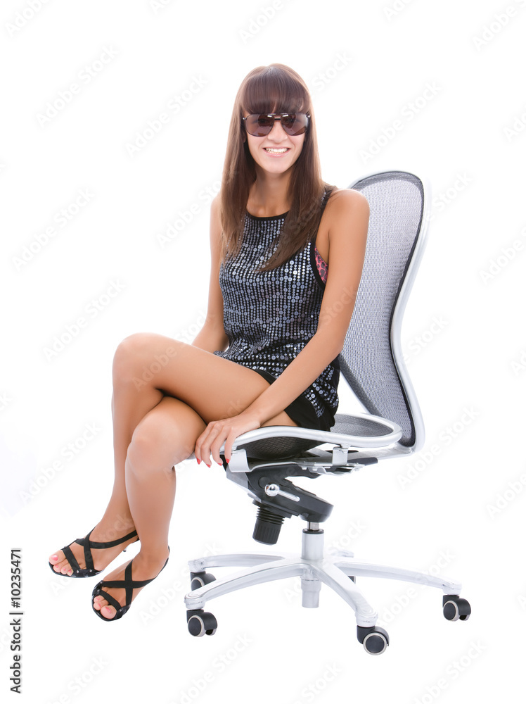 Young woman sit at armchair and smiling over white Young woman sit at armchair and smiling over white