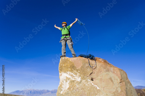 Climber on the summit of a rock spire.