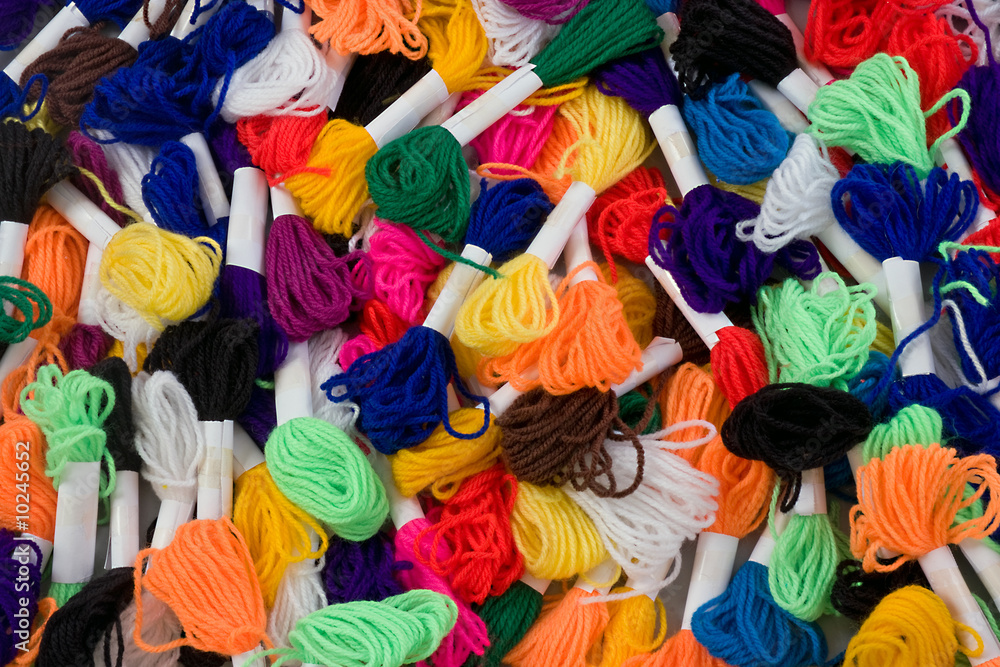 Many coloured samples of wool as a background