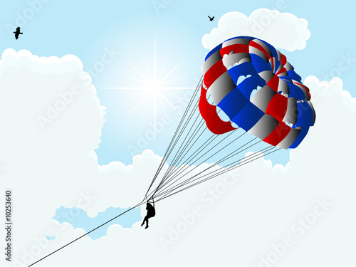 Parachute against the cloudy sky