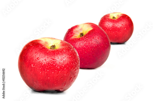 Three red apples on white background. Isolated.