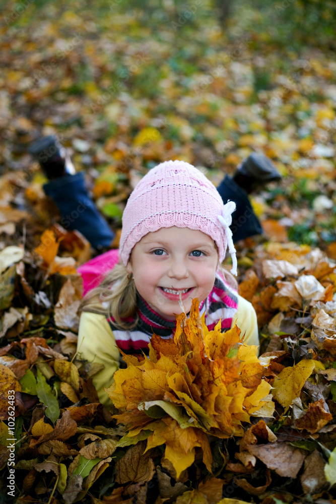 An image of girl in leaves in autumn park An image of girl in leaves in autumn park